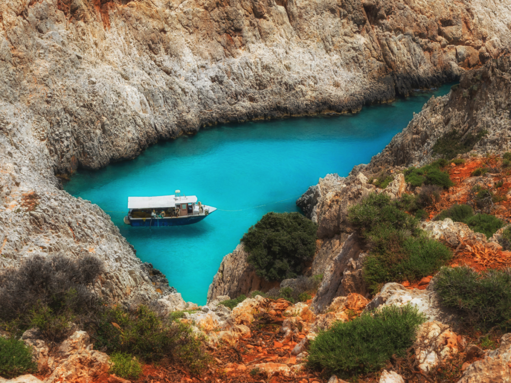 small turqiose lake in Greece seen from rocky mountains