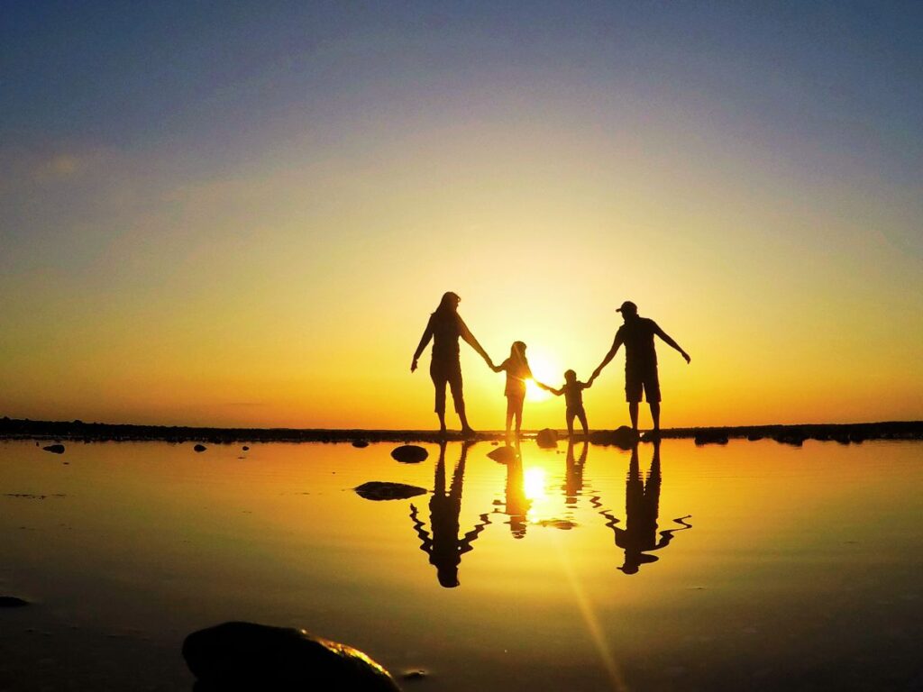 family of four walking on the beach in Miami